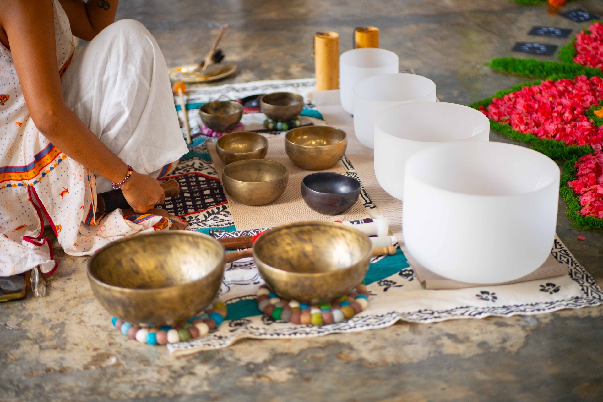 Brass and crystal singing bowls arranged for a private sound healing journey