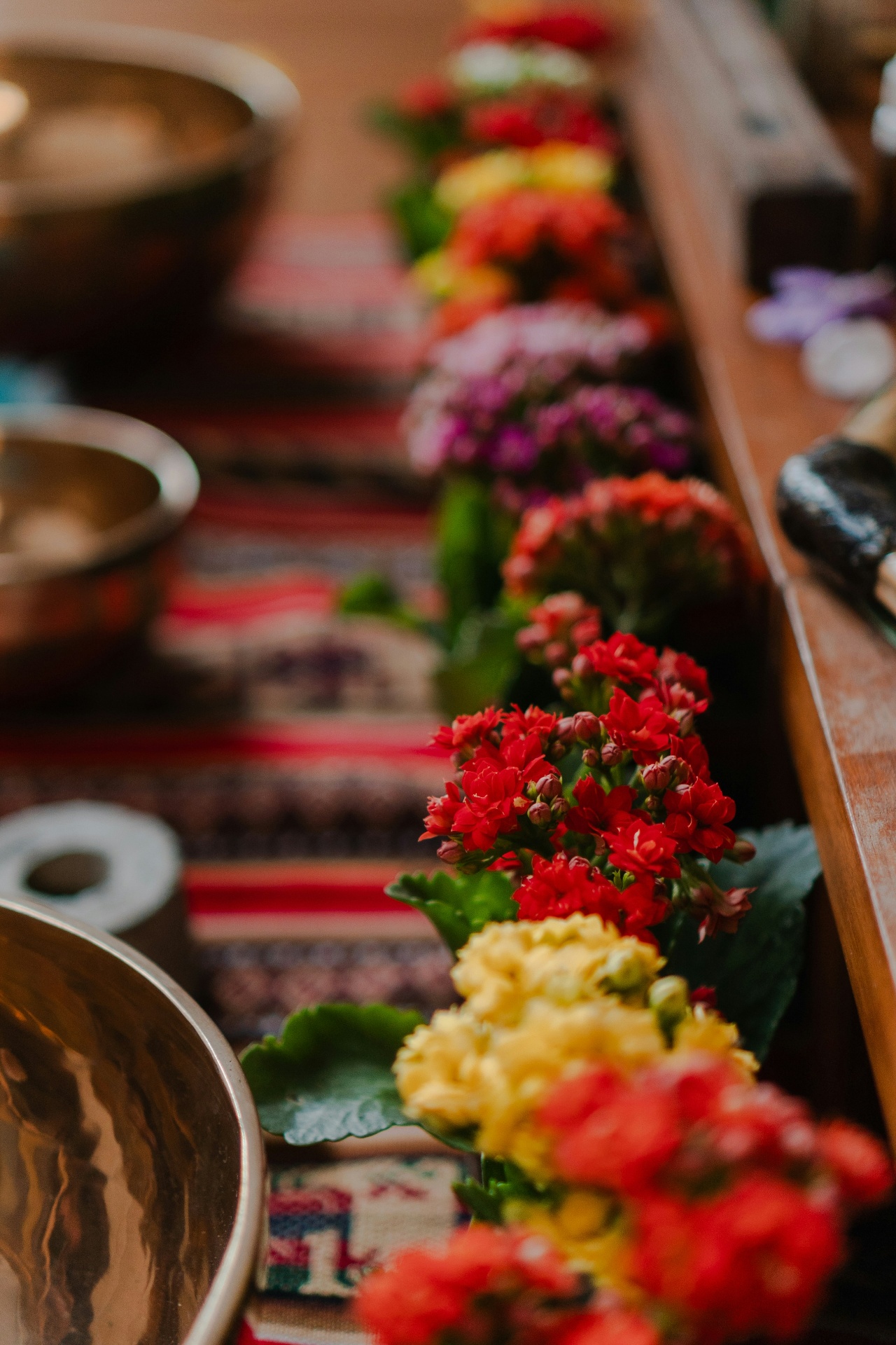 Feet resting in water with a bowl of floral salts and sage for the welcome foot scrub